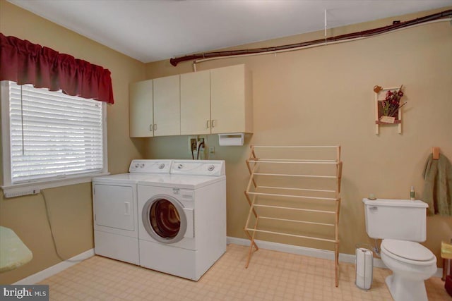 laundry area with laundry area, washer and clothes dryer, and baseboards