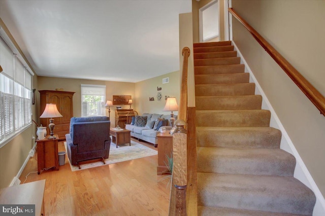 stairway with baseboards and wood finished floors