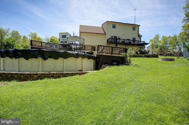 back of property featuring a lawn and a wooden deck