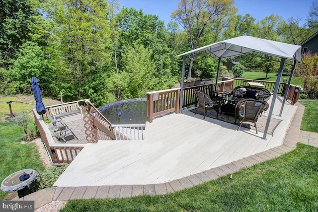 wooden terrace featuring outdoor dining area, a lawn, and a gazebo