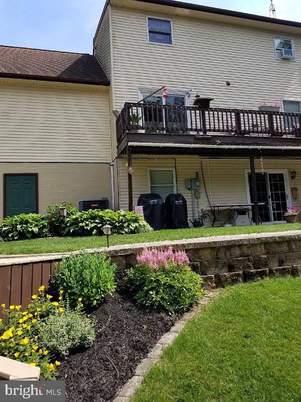 back of house featuring a deck
