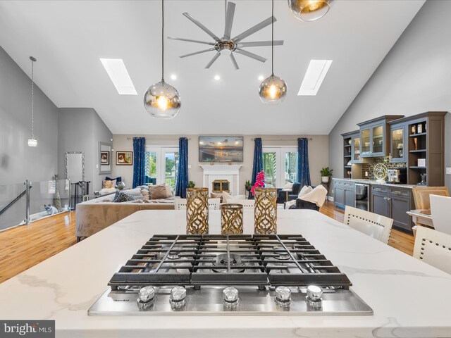 13295 Rollie Road E Rd, Bishopville, MD 21813 - kitchen featuring a skylight, high vaulted ceiling, open floor plan, wood finished floors, and plenty of natural light