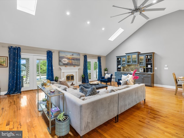 13295 Rollie Road E Rd, Bishopville, MD 21813 - living room featuring a skylight, high vaulted ceiling, a ceiling fan, light wood finished floors, and plenty of natural light
