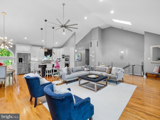 13295 Rollie Road E Rd, Bishopville, MD 21813 - living room featuring a ceiling fan, light wood-type flooring, high vaulted ceiling, recessed lighting, and a chandelier