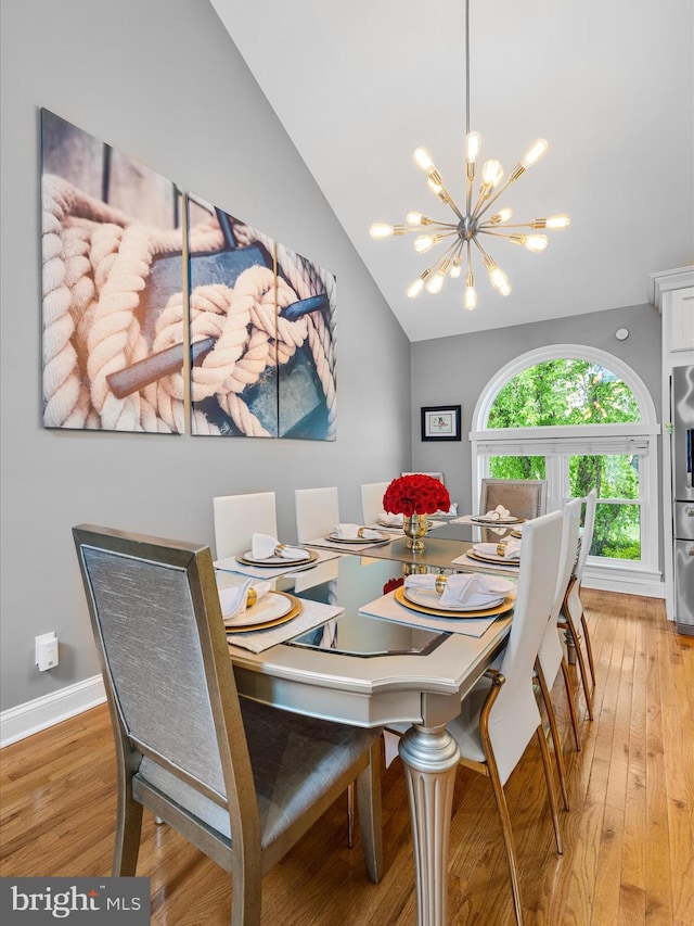 13295 Rollie Road E Rd, Bishopville, MD 21813 - dining space with a chandelier, light wood finished floors, vaulted ceiling, and baseboards