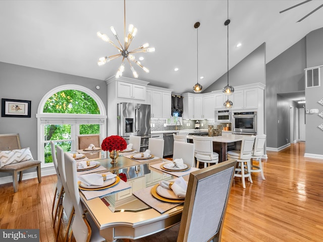 13295 Rollie Road E Rd, Bishopville, MD 21813 - dining space featuring high vaulted ceiling, light wood-style floors, a chandelier, baseboards, and recessed lighting