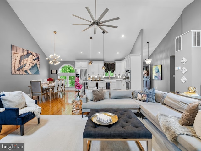 13295 Rollie Road E Rd, Bishopville, MD 21813 - living room with high vaulted ceiling, light wood-style floors, ceiling fan, a chandelier, and recessed lighting