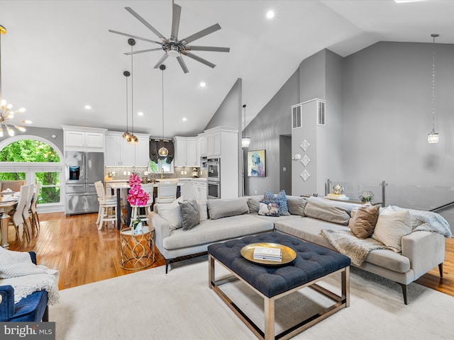 13295 Rollie Road E Rd, Bishopville, MD 21813 - living area with a ceiling fan, high vaulted ceiling, light wood-style flooring, a chandelier, and recessed lighting