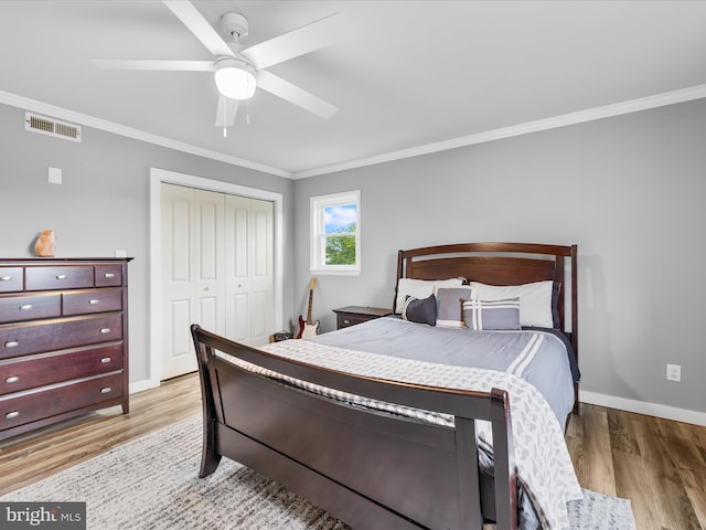 13295 Rollie Road E Rd, Bishopville, MD 21813 - bedroom with ornamental molding, light wood-style floors, baseboards, a closet, and a ceiling fan