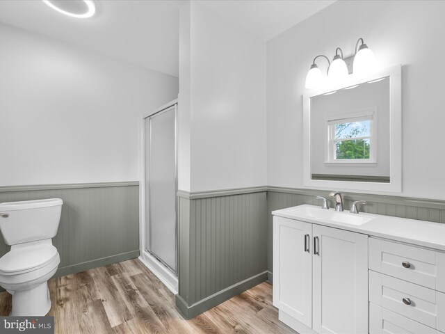 13295 Rollie Road E Rd, Bishopville, MD 21813 - full bath with wainscoting, a stall shower, toilet, wood finished floors, and vanity
