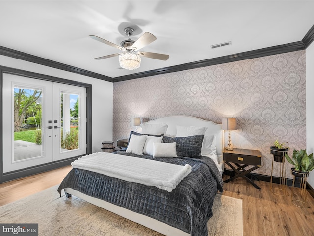 13295 Rollie Road E Rd, Bishopville, MD 21813 - bedroom with wallpapered walls, ornamental molding, french doors, wood finished floors, and access to exterior