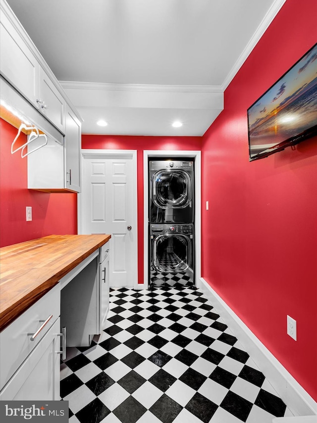 13295 Rollie Road E Rd, Bishopville, MD 21813 - washroom featuring stacked washer / dryer, dark flooring, crown molding, cabinet space, and baseboards