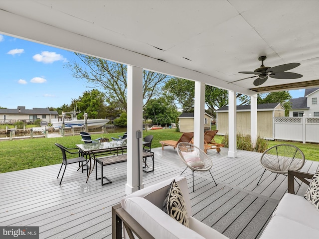 13295 Rollie Road E Rd, Bishopville, MD 21813 - wooden deck with an outdoor structure, ceiling fan, and outdoor dining space