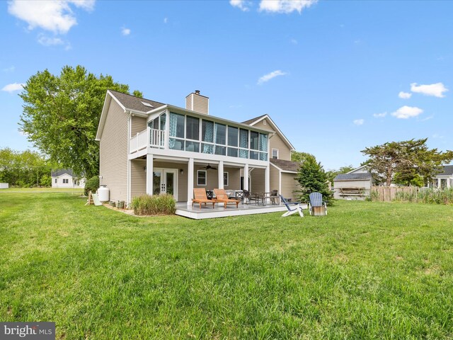13295 Rollie Road E Rd, Bishopville, MD 21813 - rear view of property featuring a sunroom, french doors, a chimney, and a lawn