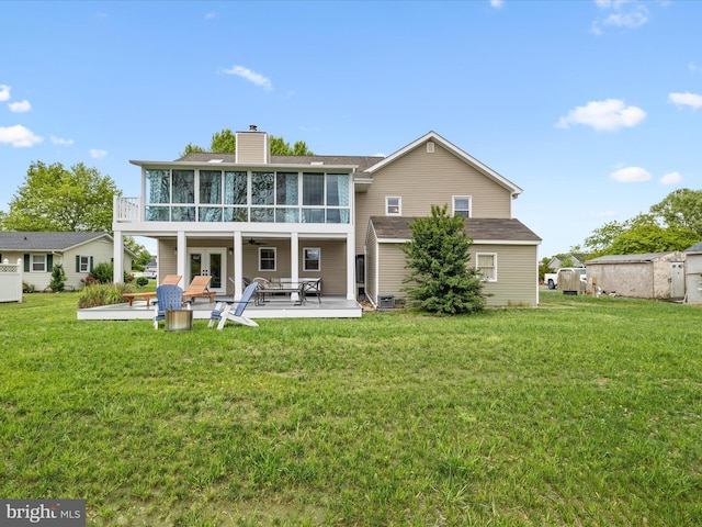 13295 Rollie Road E Rd, Bishopville, MD 21813 - back of property with a sunroom, a patio area, a chimney, a yard, and french doors