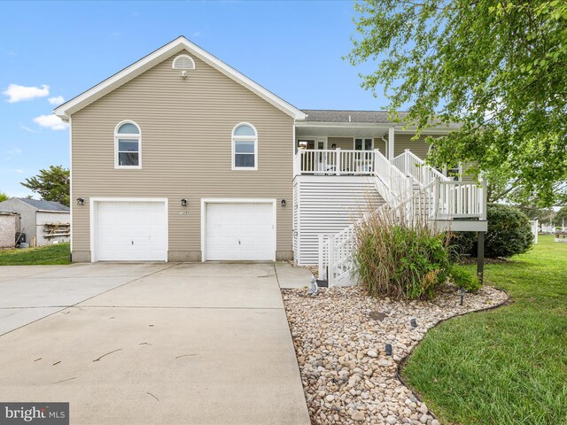 13295 Rollie Road E Rd, Bishopville, MD 21813 - view of front of house with an attached garage, driveway, stairs, a front lawn, and covered porch