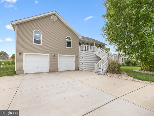13295 Rollie Road E Rd, Bishopville, MD 21813 - view of front facade featuring a garage, concrete driveway, stairs, and a porch