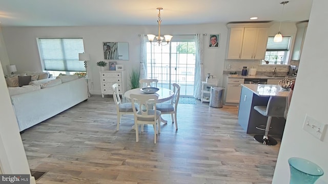 13 Verbena Dr, Lancaster, PA 17602 - dining space with light wood-style floors, a healthy amount of sunlight, and an inviting chandelier
