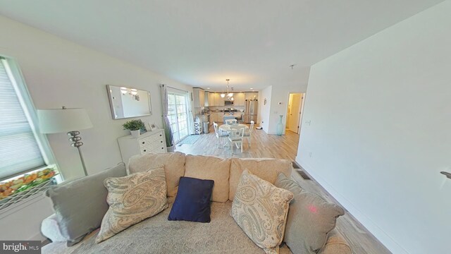 13 Verbena Dr, Lancaster, PA 17602 - living room with an inviting chandelier, light wood finished floors, and baseboards