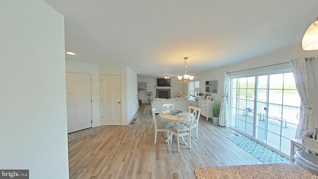 13 Verbena Dr, Lancaster, PA 17602 - dining space featuring an inviting chandelier, baseboards, a fireplace, and light wood-type flooring
