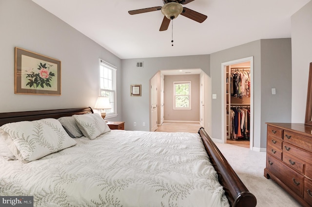 9504 Broome Ct, Vienna, VA 22182 - bedroom with a walk in closet, arched walkways, a closet, baseboards, and light colored carpet