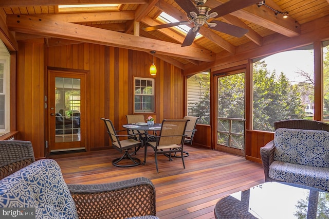 sunroom featuring beam ceiling and a wealth of natural light