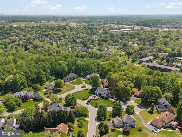 drone / aerial view featuring a residential view and a forest view