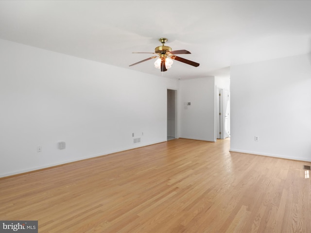 unfurnished room with ceiling fan, visible vents, baseboards, and light wood finished floors