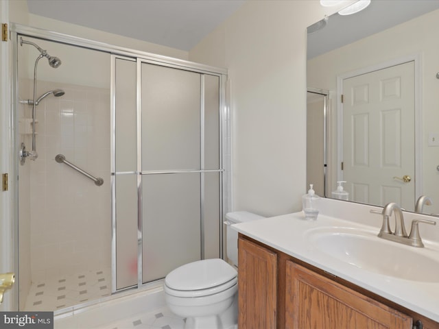 full bathroom with vanity, a stall shower, and toilet