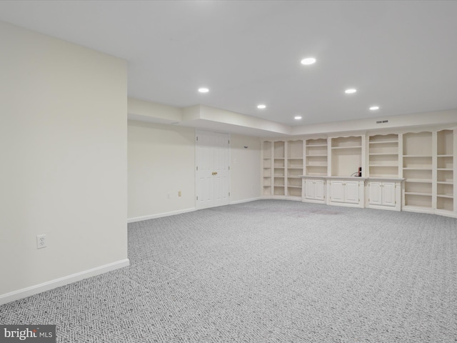 finished below grade area with light colored carpet, recessed lighting, and baseboards
