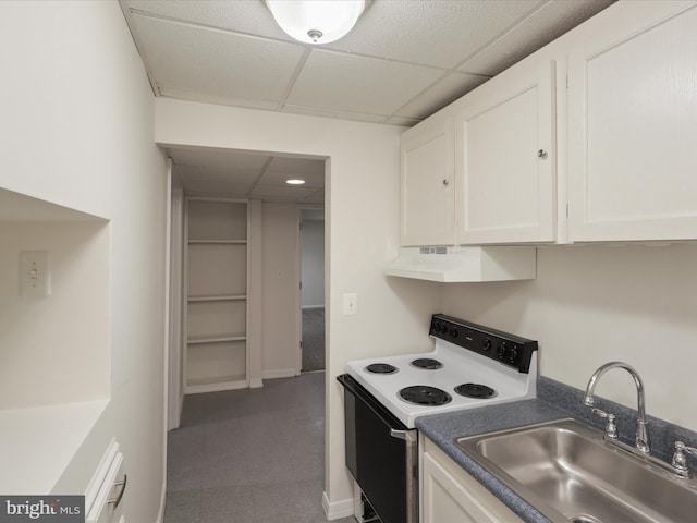 kitchen with a drop ceiling, electric range oven, a sink, white cabinets, and under cabinet range hood