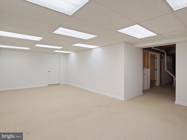 unfurnished room with baseboards and a paneled ceiling