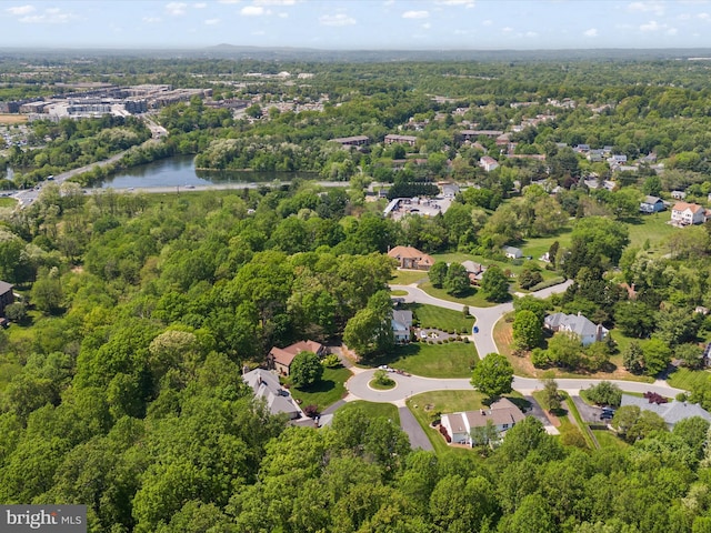 drone / aerial view featuring a water view and a forest view
