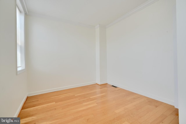 524 S Luzerne Ave, Baltimore, MD 21224 - spare room featuring crown molding, light wood-style floors, and baseboards