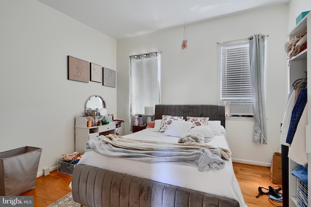 524 S Luzerne Ave, Baltimore, MD 21224 - bedroom with light wood-style floors, baseboards, and cooling unit