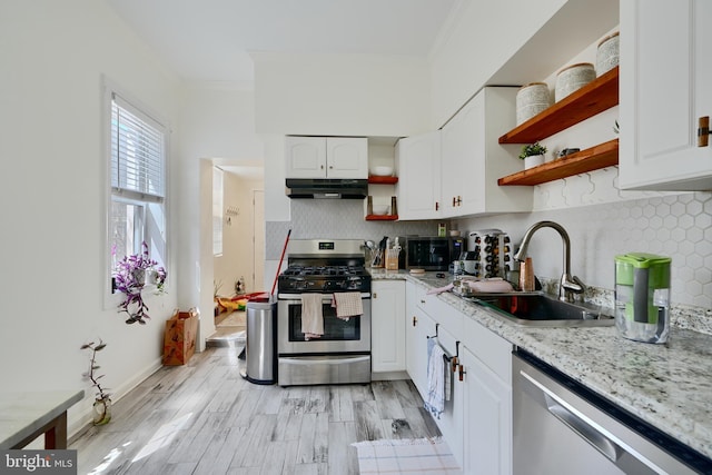 524 S Luzerne Ave, Baltimore, MD 21224 - kitchen featuring appliances with stainless steel finishes, open shelves, a sink, ornamental molding, and under cabinet range hood