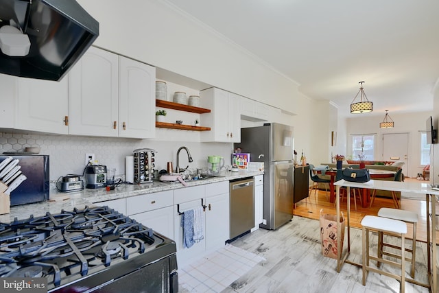 524 S Luzerne Ave, Baltimore, MD 21224 - kitchen with appliances with stainless steel finishes, ventilation hood, a sink, ornamental molding, and backsplash
