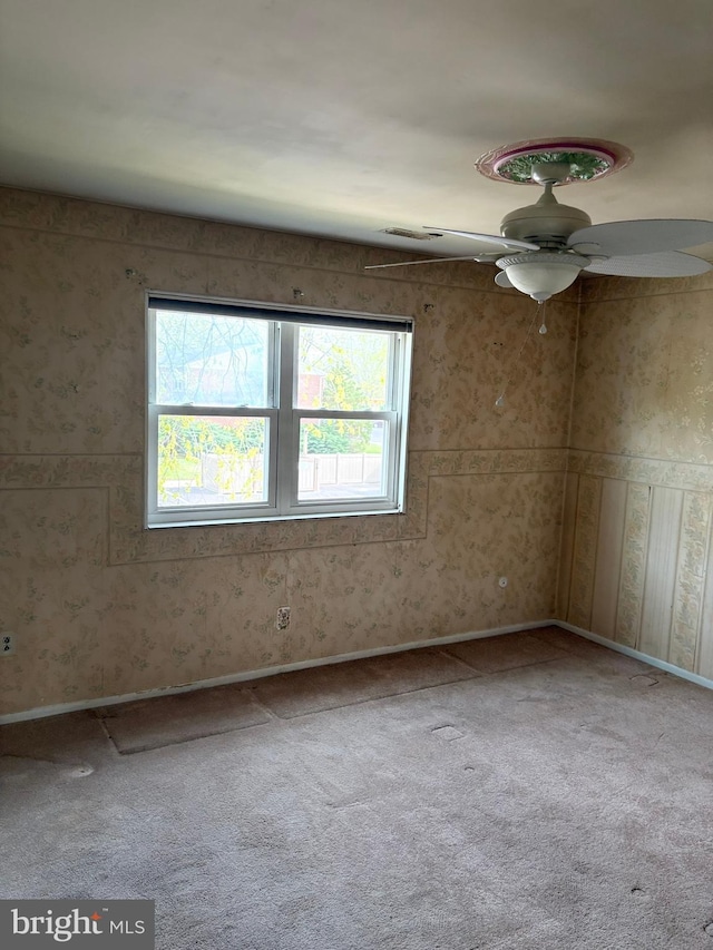 unfurnished room with baseboards, carpet, and ceiling fan
