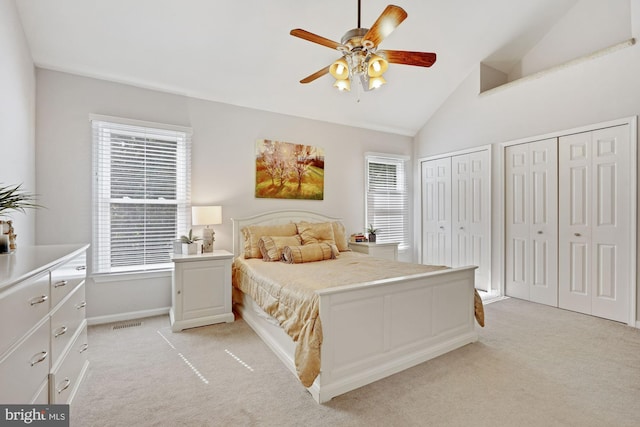 7228 Lensfield Ct, Alexandria, VA 22315 - bedroom featuring light colored carpet, multiple windows, multiple closets, and vaulted ceiling