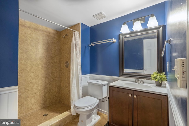 7228 Lensfield Ct, Alexandria, VA 22315 - bathroom with a tile shower, vanity, wainscoting, and tile patterned floors