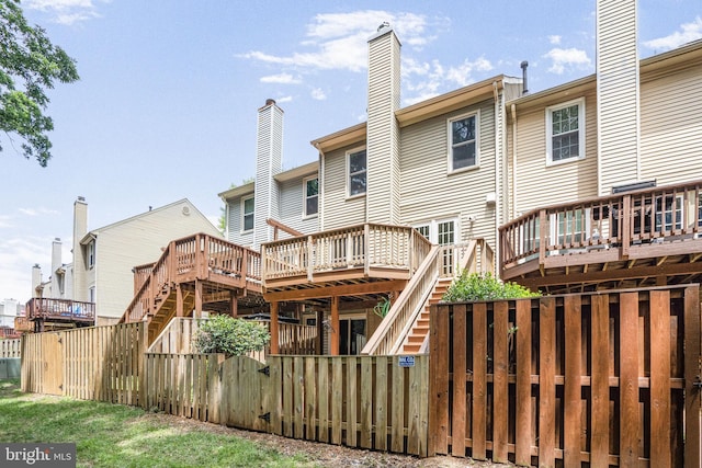 7228 Lensfield Ct, Alexandria, VA 22315 - back of house with stairway, a deck, and a chimney