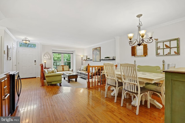 7228 Lensfield Ct, Alexandria, VA 22315 - dining room with wood-type flooring, a chandelier, and ornamental molding