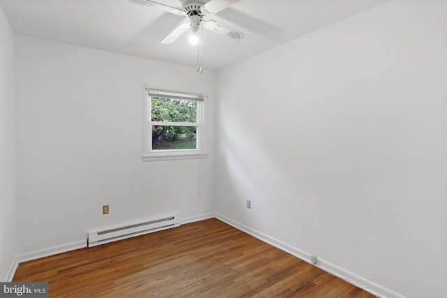 unfurnished room featuring baseboard heating, wood finished floors, baseboards, and ceiling fan