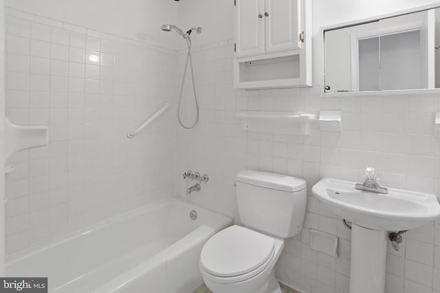 bathroom featuring toilet, tile walls, and tub / shower combination