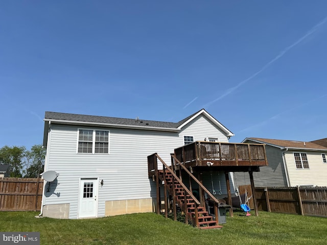 rear view of house featuring stairway, fence, a yard, and a deck
