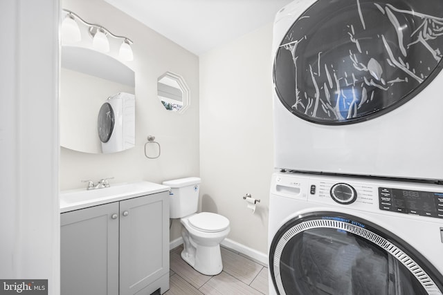 6 Plymouth Ter, Egg Harbor Township, NJ 08234 - bathroom with vanity, baseboards, toilet, and stacked washer / dryer