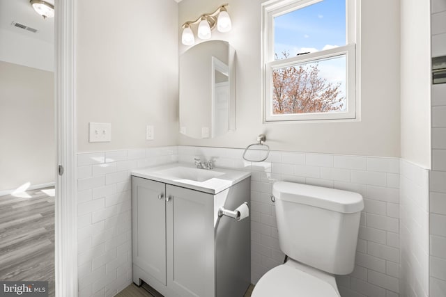 6 Plymouth Ter, Egg Harbor Township, NJ 08234 - bathroom featuring visible vents, vanity, wainscoting, toilet, and tile walls