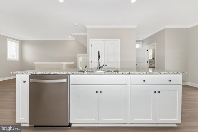 kitchen featuring a sink, white cabinets, stainless steel dishwasher, and crown molding