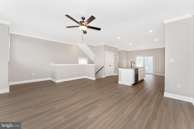 unfurnished living room with crown molding, dark wood-style flooring, ceiling fan, and baseboards
