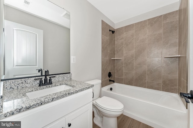bathroom featuring vanity, toilet,  shower combination, and visible vents